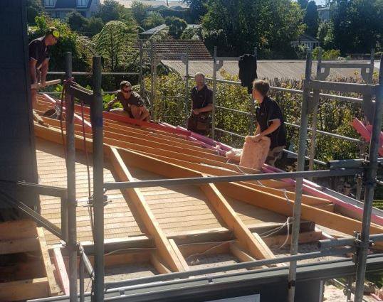 Adding insulation to the new roof that covers the extension